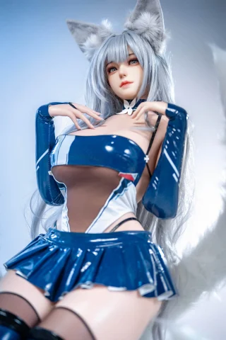 Pose emphasizes a playful stance with hands near the face. Outfit features a glossy blue bodysuit and skirt, complemented by long, silver hair and fox-like ears.