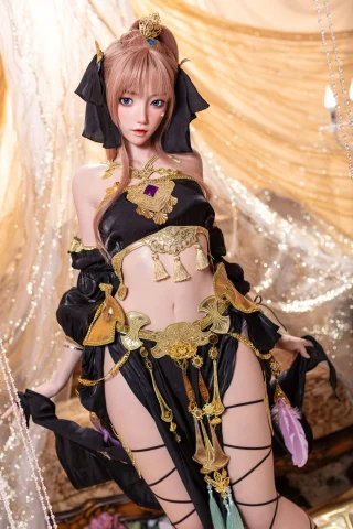 Dancing girl in ornate black outfit with gold accents, featuring a midriff-baring top and intricate accessories, posed elegantly.
