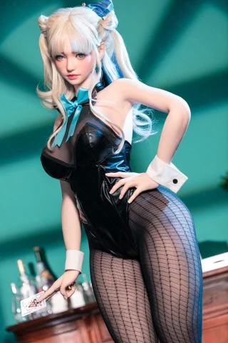 Doll in a black bodysuit with a blue bow, fishnet stockings, and playful pose; soft blonde hair, holding a playing card.