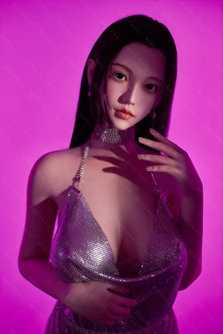 Subject features a shimmering silver dress with a deep neckline, long straight hair, and a soft expression against a pink backdrop.