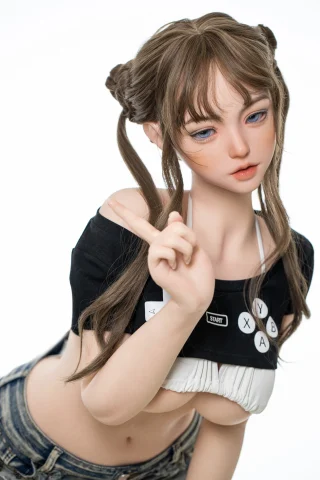Subject features a playful pose with a finger raised. Dressed in a cropped black top and denim shorts, showcasing a casual style.