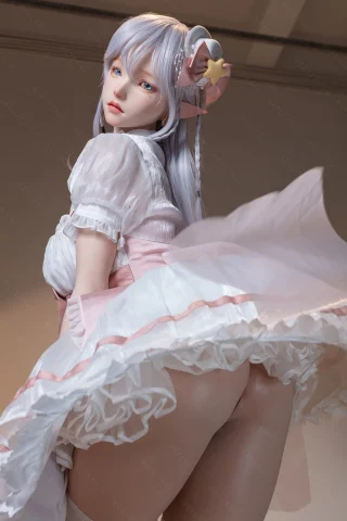 Doll features a pastel dress with ruffled layers, long silver hair, and a star-themed hair accessory, posed playfully from behind.