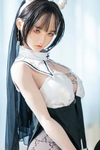 Subject features a doll with a playful pose, wearing a black and white outfit with lace details. The setting is bright, enhancing the doll's striking blue eyes and intricate accessories.