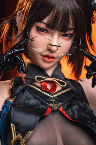 Subject features a doll with dark hair styled in pigtails, wearing a black outfit with intricate details, and glasses. The background is warm-toned.