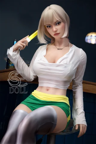 The image features a doll with short, platinum blonde hair and a confident expression. She wears a white, fitted top that accentuates her figure, paired with green shorts that have a yellow stripe. The doll is seated, holding a glowing object, possibly a drink or accessory, and is set against a dimly lit background with a bar-like atmosphere.