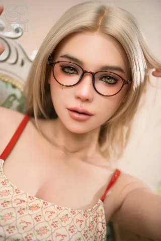Natural Maggie doll with glasses, featuring realistic details and a lifelike appearance. Ideal for collectors.