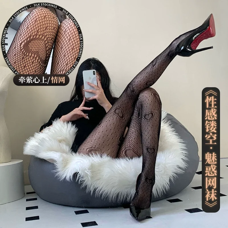 sexy-jacquard-fishnet-black-silk-stockings-220ca59e Sexy jacquard fishnet black silk stockings feature a heart pattern, worn by a person reclining in a plush chair.