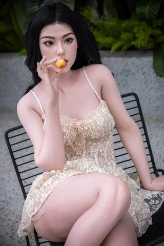 Qingwen doll, 163cm, wearing a lace dress, sitting on a chair, holding a slice of fruit.