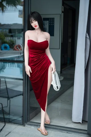 Wushi 171cm C-Cup doll in a red strapless dress, standing by a glass door with a pool in the background.