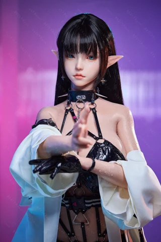 Bezlya doll 157cm in a black latex outfit with long black hair and pointed ears, posing with a hand gesture.