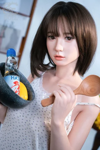 Hinata doll 153cm holding a bowl and a wooden spoon, wearing a light tank top with short brown hair.